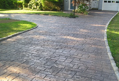 Old weathered stamped concrete driveway.