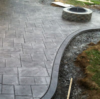 Stamped concrete patio with subtle landscaping.