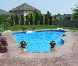 Backyard pool with a pool deck made from decorative concrete.