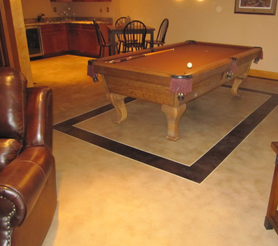 Decorative interior flooring in a game room with square detail.