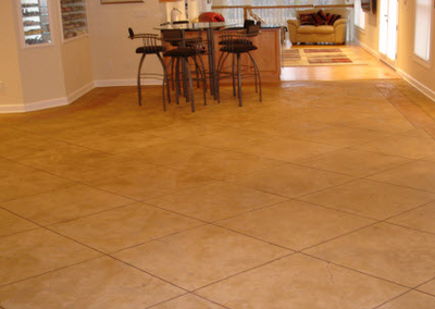 Concrete flooring done inside main level of home, cut to resemble tile flooring.