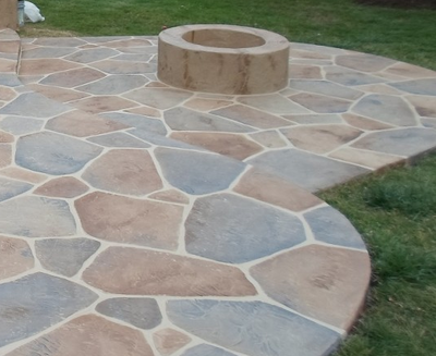 Multicolored gray and brown sandstone styled concrete patio.
