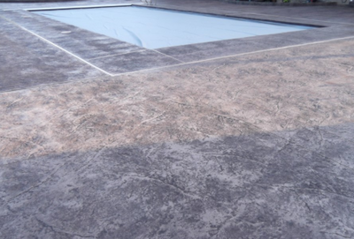Stamped gray colored concrete pool deck.
